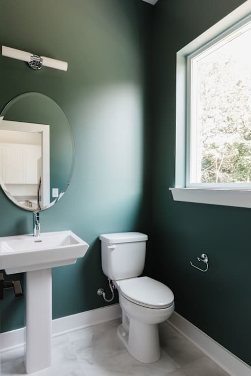 A white toilet sits next to a sink in a bathroom.at The Yarra, Tennessee