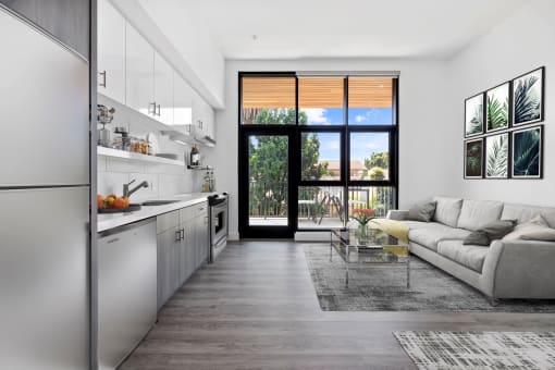 White living room with a kitchen and a balcony at Edendale Crossing, CA 90026