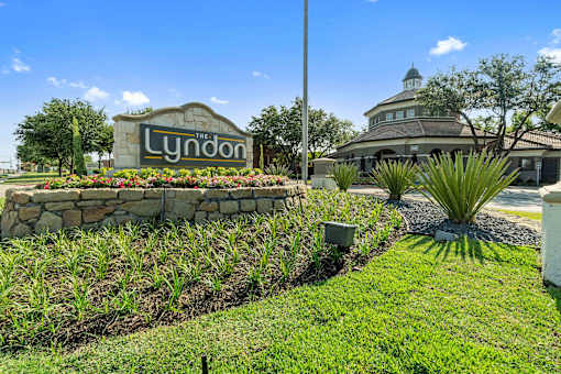 A sign that says "Lyndon" in front of a house.