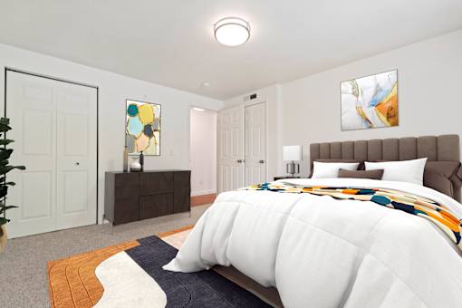 A bedroom with a large bed and a painting on the wall.