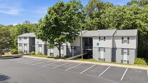 A parking lot in front of apartment buildings.