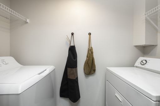In unit washer and dryer with overhead storage at Canyon Creek Apartments, Oregon, 97070