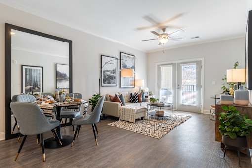 A modern dining room with a large mirror and a dining table set with plates.
