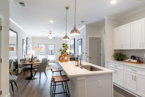 A modern kitchen with a dining table and chairs.