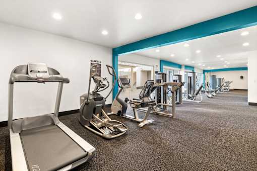 A gym with treadmills, weights and exercise machines at The Fulton, Los Angeles
