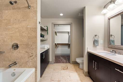 A bathroom with a walk-in shower and a white bathtub.