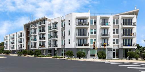 A modern apartment building with balconies and multiple floors.