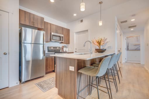 a kitchen with wood cabinets and stainless steel appliances