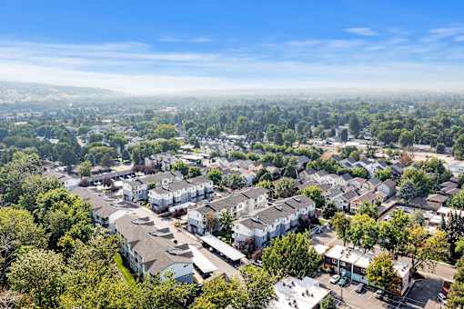 A bird's eye view of a residential area with houses and trees.