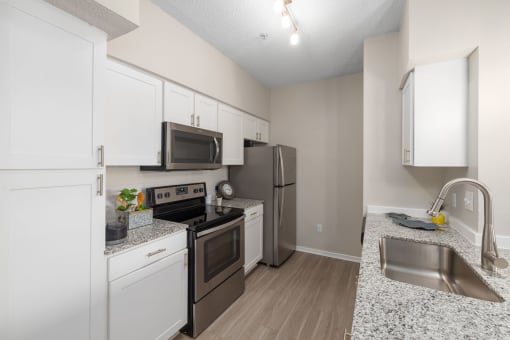 a kitchen with stainless steel appliances and granite counter tops