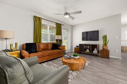 Living room with green curtains and leather couch