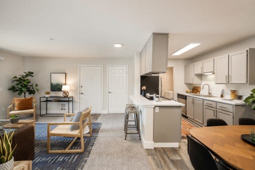 Open concept living and kitchen with island seating at Canyon Creek Apartments, Wilsonville