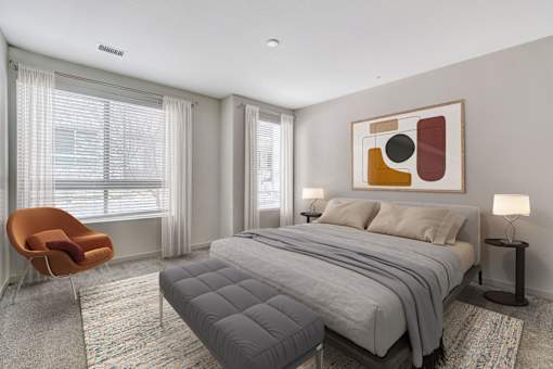 A bedroom with a large bed, a chair, and a painting on the wall.