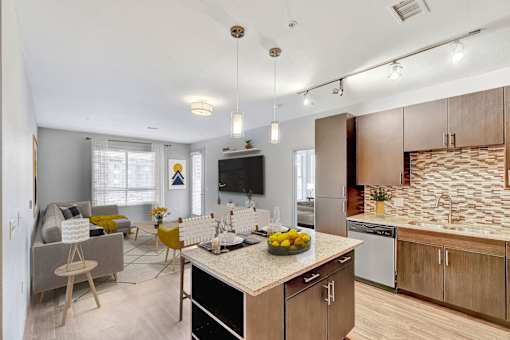 A modern kitchen with a dining area and a living room.