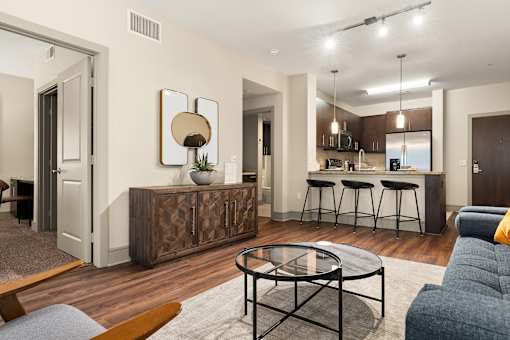 A modern living room with a wooden coffee table and a bar area.