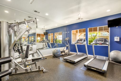 a gym with cardio equipment and weights at Montessa at Whitney Ranch