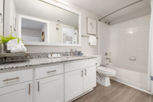 spacious bathroom white white cabinets and a bath tub