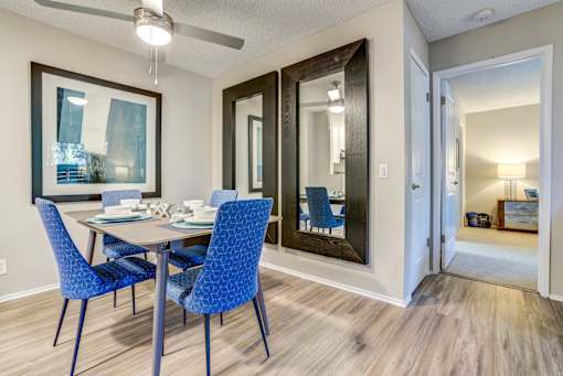 A dining room with a table and chairs.
