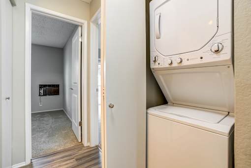 A white dryer is sitting in a small room.