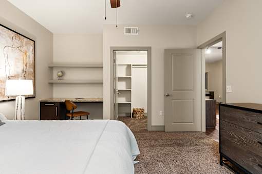 A bedroom with a bed, dresser, and mirror.