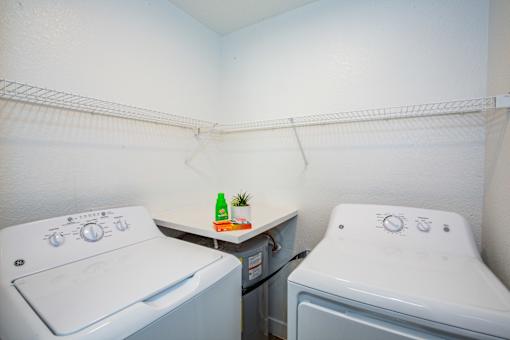 A small laundry room with a washer and dryer.