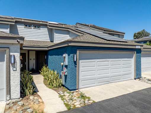 A blue townhome with an attached garage.
