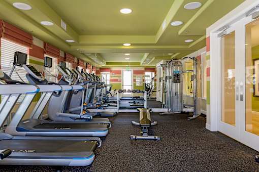 A gym with treadmills and exercise equipment.