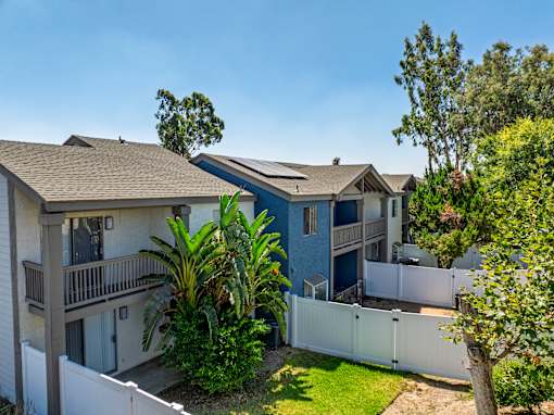 Townhomes with individual lush green yards.