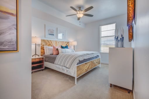 a bedroom with a bed and a ceiling fan