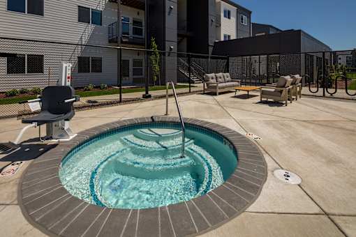 Small round pool with a waterfall in the middle at The Arvon, Vancouver, 98662