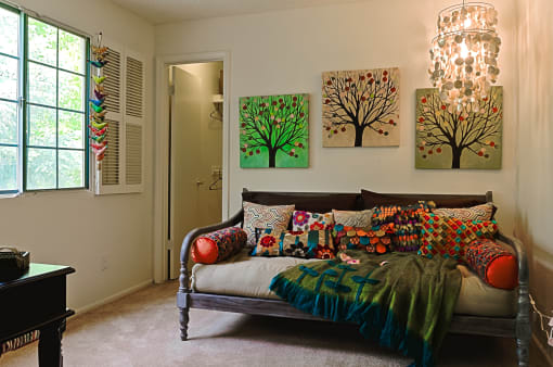 a bedroom with a bed and paintings on the wall