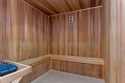 A sauna with a bench and a light switch.