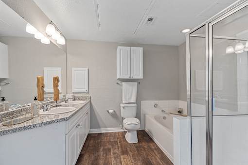 A white bathroom with a toilet, sink, and bathtub.