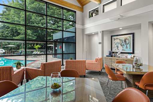 A modern dining room with a glass table and chairs.