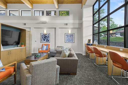 A room with a grey carpet and a wooden ceiling.