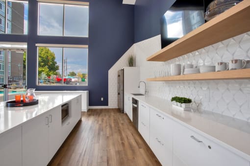 a kitchen with white cabinets and blue walls