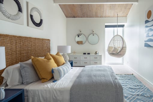 a bedroom with window and chair