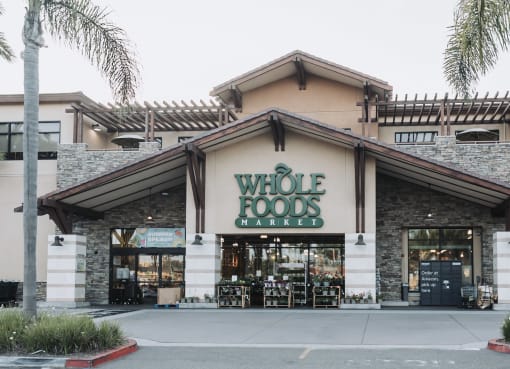 a whole foods market with a sign on the front of it