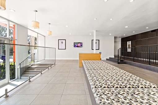 A hallway with a patterned floor mat and a yellow bench at The Fulton, Los Angeles, CA, 91423.