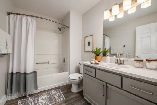 Bathroom with gray vanity and white subway tile at Canyon Creek Apartments, Wilsonville, 97070