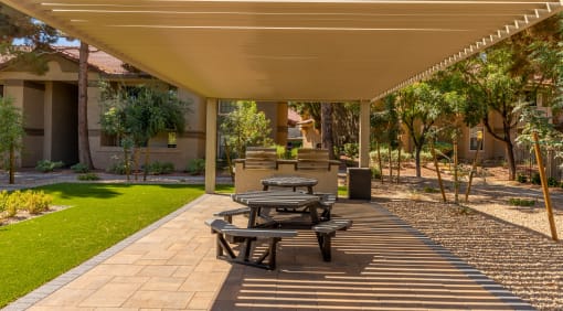 Outdoor BBQ grill area with outdoor seating, shade cover