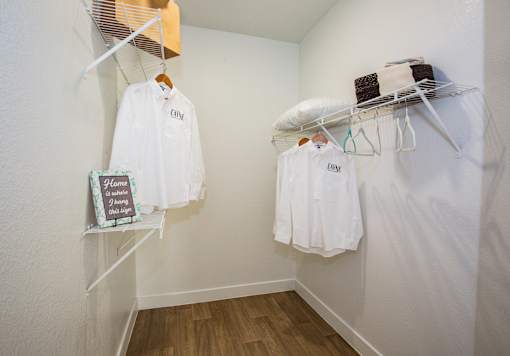 A white shirt with the word "City" on it hangs on a clothes rack.