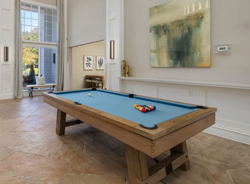 pool table in clubhouse with large windows