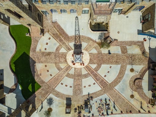 a view of the clock tower in the center of the plaza of a city square
