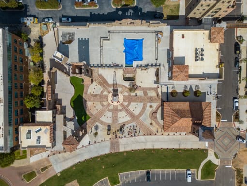 a birds eye view of a building with a blue tarp on the roof