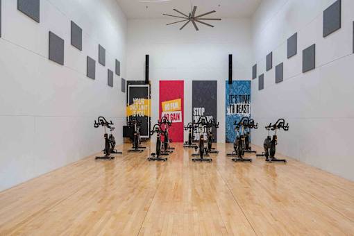 A gym with exercise bikes and motivational posters.