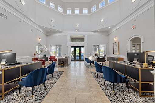 A large, open office space with rows of desks and chairs.