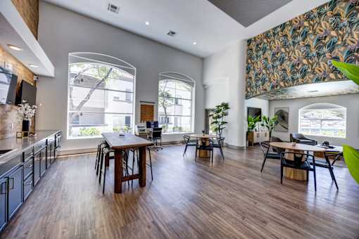 A modern resident lounge with a dining table and chairs.