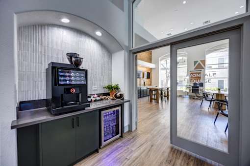 A modern clubhouse with a coffee machine on the counter.