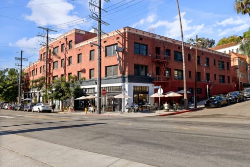a large brick building on a city street at Del Mor Apartments, Los Angeles, California